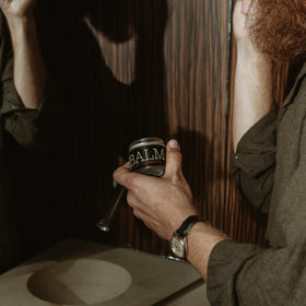 18.21 Man Made jar in hand demonstrating compact 2 oz size and travel-ready benefit