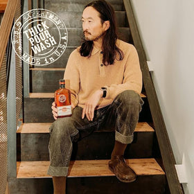 18.21 Man Made bottle staged in speakeasy-style scene conveying premium scent