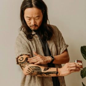 18.21 Man Made tattooed skin treated with oil, emphasizes hydrated vibrant ink