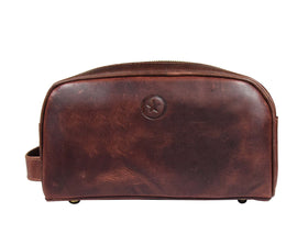AARON LEATHER GOODS pouch inside a packed suitcase demonstrating travel readiness