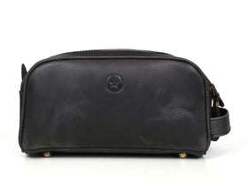 AARON LEATHER GOODS next to toiletries showing king-size capacity for packing