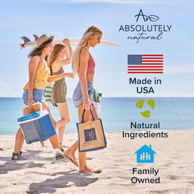 Absolutely Natural bottle on beach towel implying post-sun care benefit