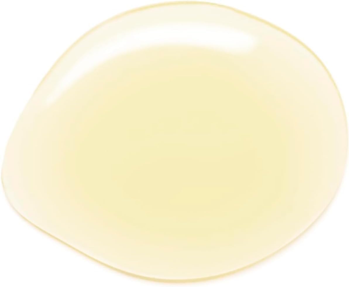 Hand applying Acure argan oil to hair ends to reduce frizz and add shine