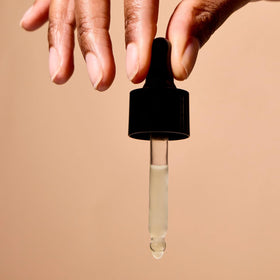 Closeup of argan oil drop texture showcasing Acure smooth absorption benefit