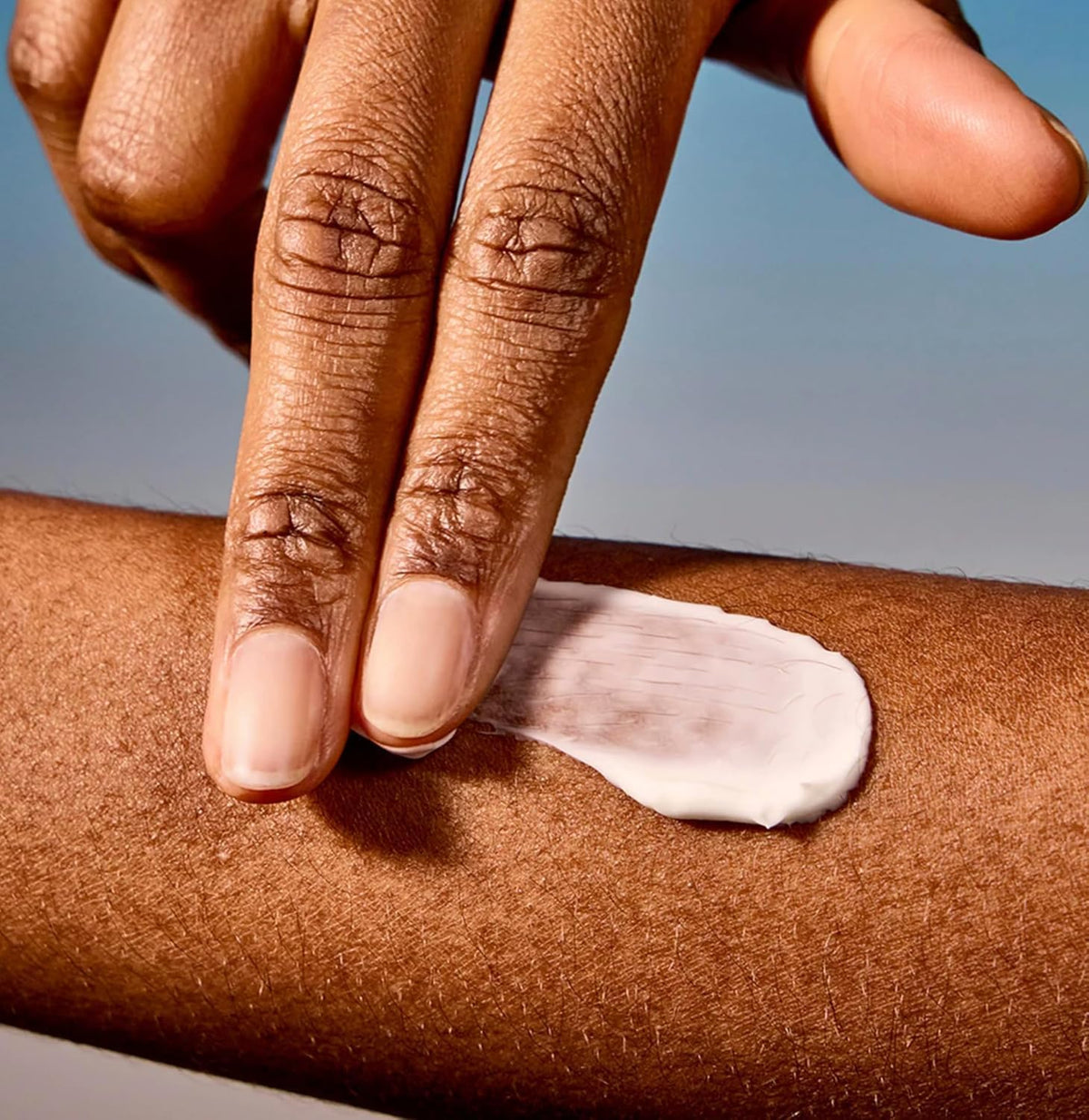 Acure applying day cream to hand illustrating quick absorption and non-greasy benefit