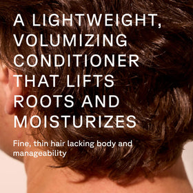 Acure squeezing conditioner from cap onto palm showing easy-use benefit