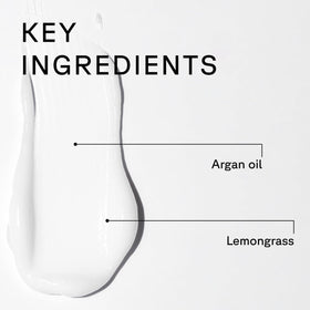 Acure bottles next to hand showing 8 fl oz scale and travel convenience