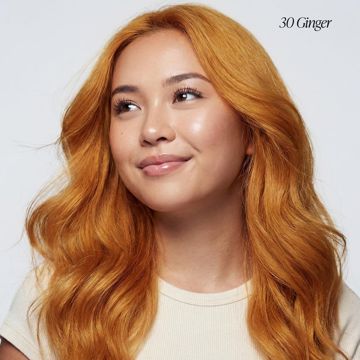 Adore color swatch on hair strand displaying vibrant ginger payoff benefit