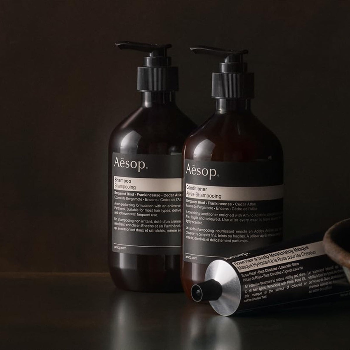 Aesop 500mL bottle held in hand for size comparison and travel practicality