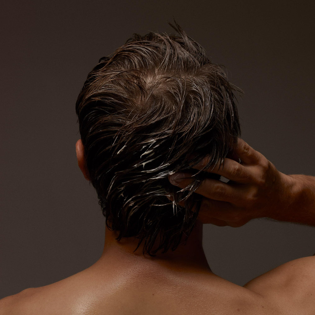 Aesop conditioner being applied to wet hair in shower, helps detangle and hydrate