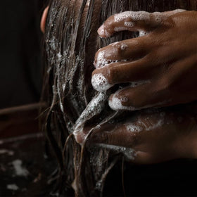 Aesop bottles in a shower scene demonstrating everyday in-shower use benefits