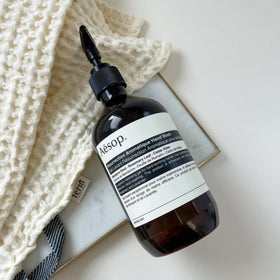 Aesop bottle styled on bathroom shelf conveying premium look and everyday ritual benefit