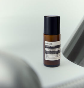Aesop roll-on being applied underarm showing targeted odor management during routine