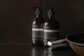Aesop shampoo being massaged into wet hair showing effective sudsing benefit