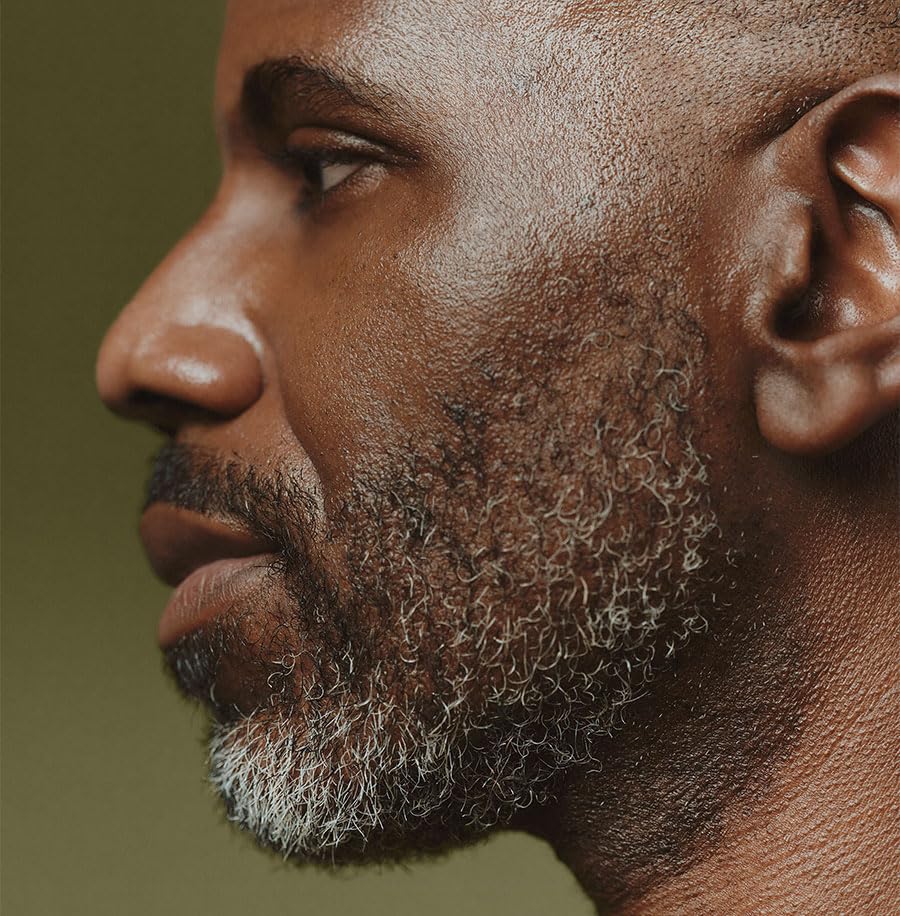 Applying Aesop oil to beard for softer, more manageable facial hair