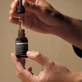 Running Aesop oil through mid-lengths to reduce frizz and add shine