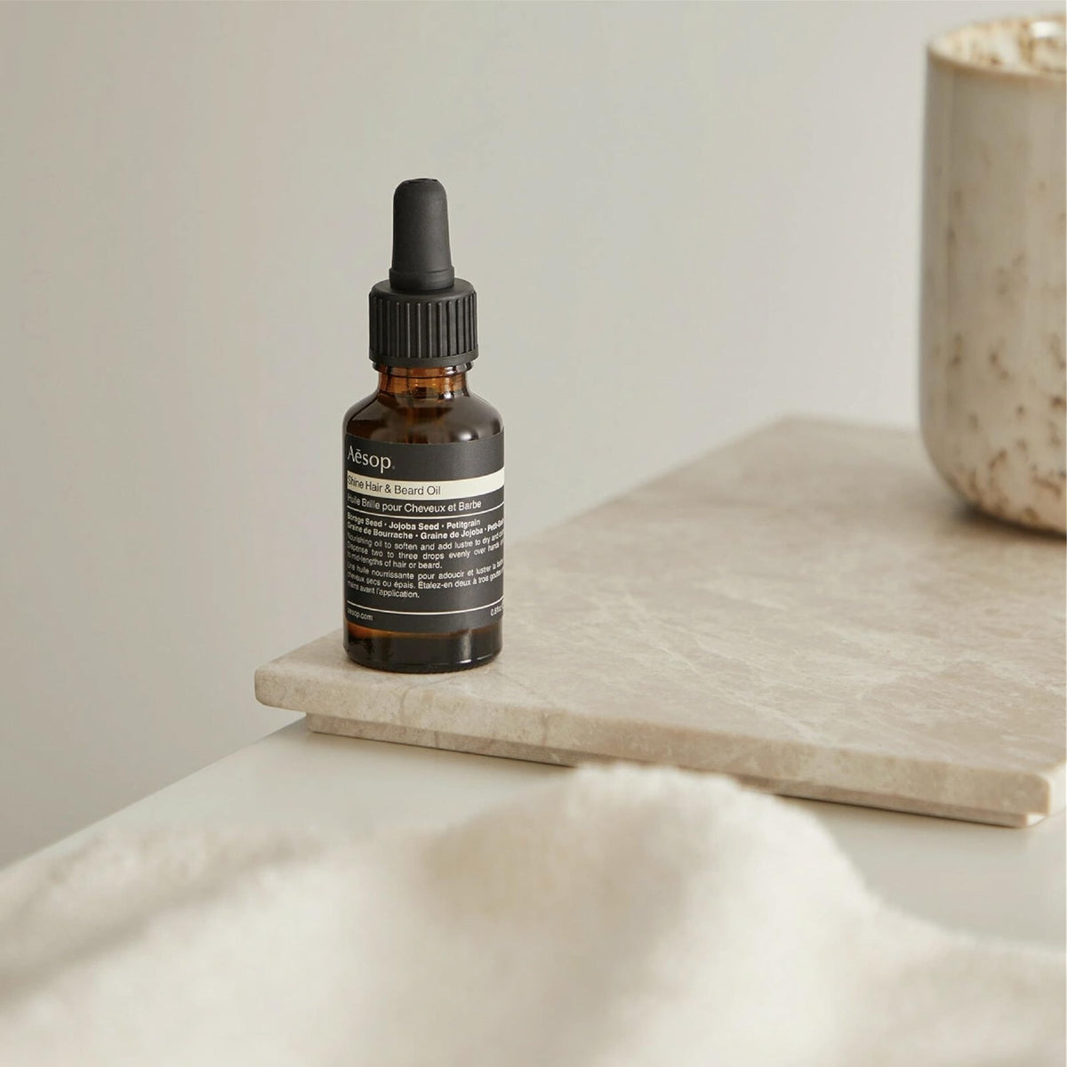 Close-up Aesop label listing botanical oils for visible ingredient transparency