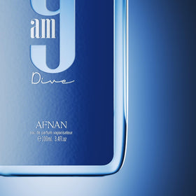 Afnan 9 AM Dive bottle on a beach morning setting, evoking aquatic freshness