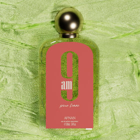 Afnan 9 AM fragrance pouring near fruits illustrating fresh vibrant notes