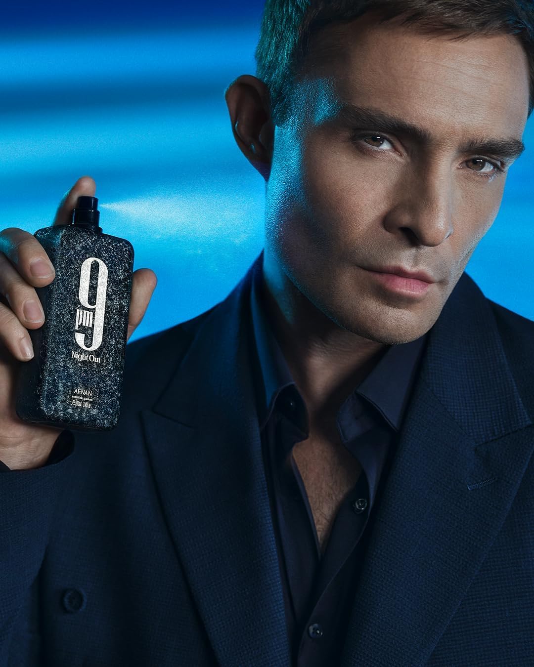 Afnan bottle beside common objects for scale showing true 3.4 fl oz size