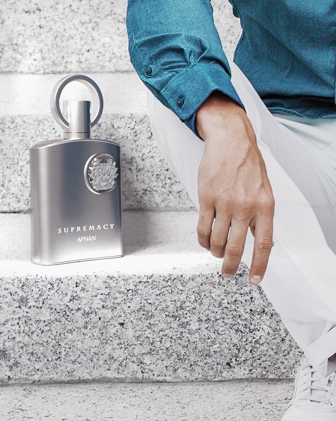 Afnan bottle in hand demonstrating 3.4 fl oz size and portability
