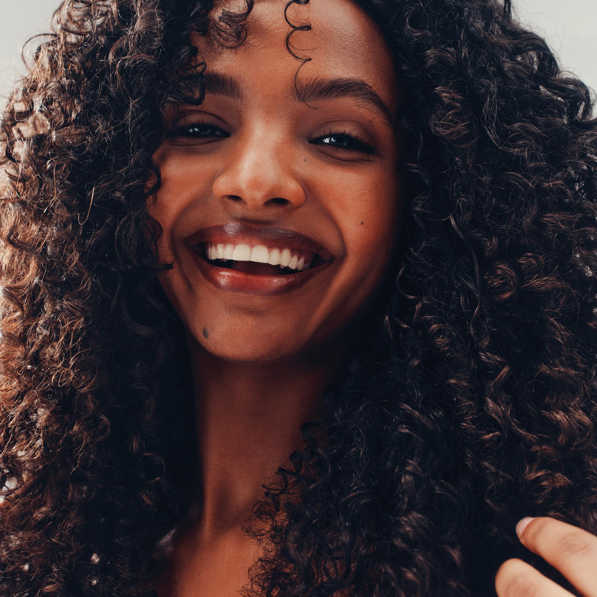 AG Care styled curls after use, displays definition and anti-frizz effect