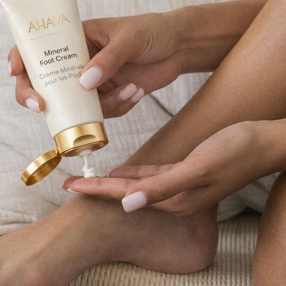 AHAVA product next to ruler/hand to show 3.4 fl oz scale and travel-friendly size benefit