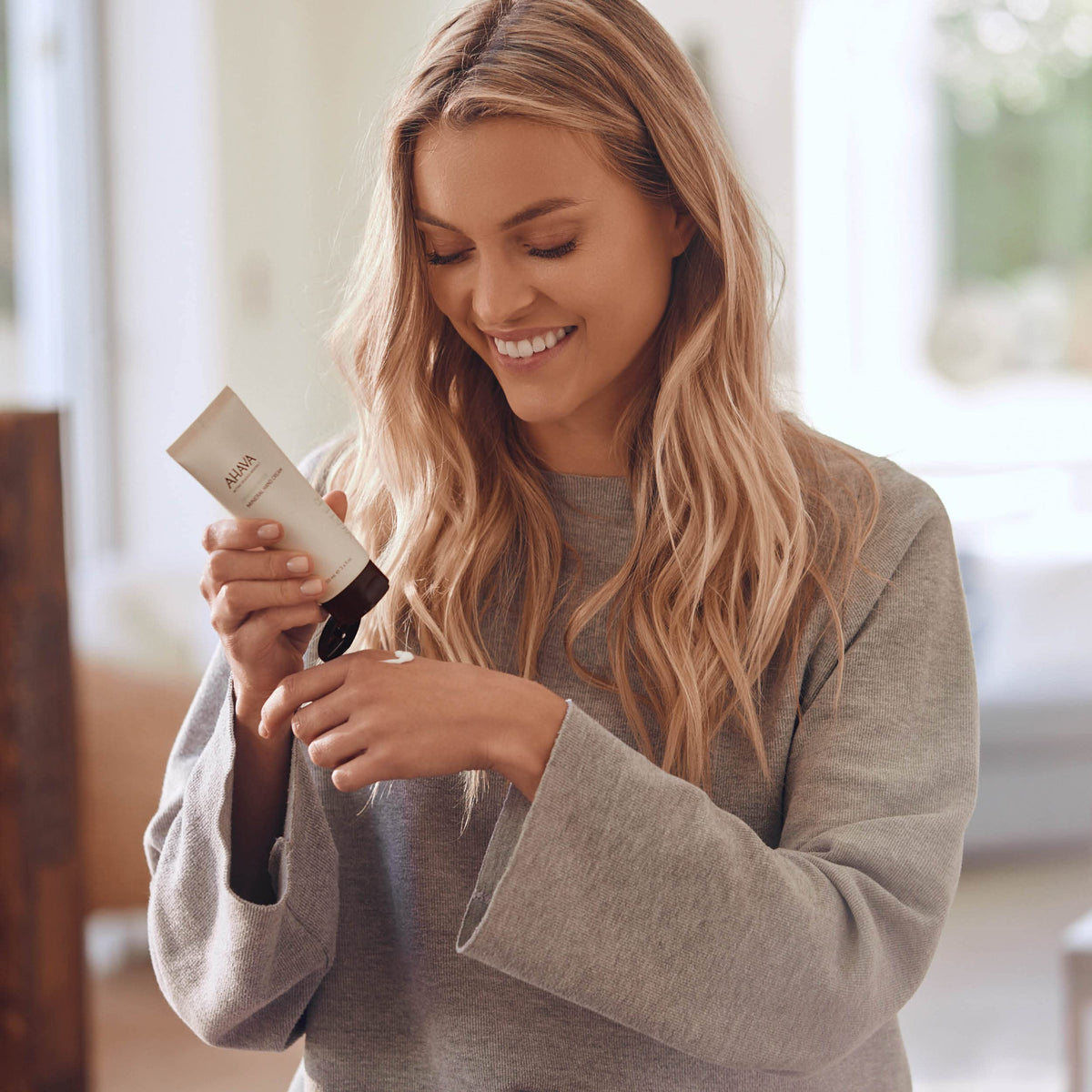 AHAVA hand cream on bathroom counter lifestyle scene, keeps hands protected daily benefit