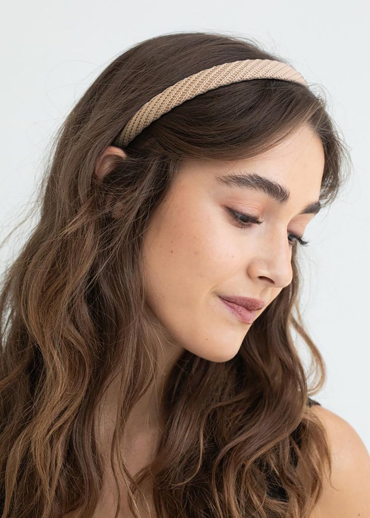 AIBFRID headband on hand for scale showing compact size and lightweight benefit