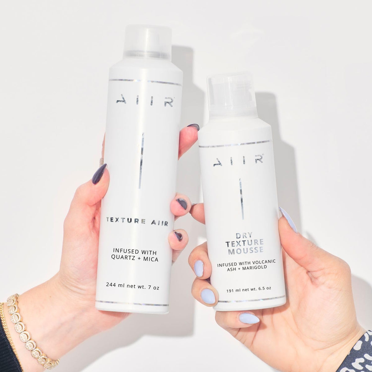 AIIR mist being sprayed into hair to create instant texture