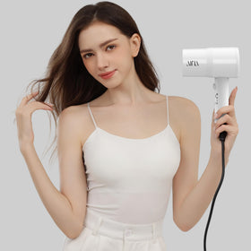 AINA dryer held in hand to show size and easy maneuverability benefit