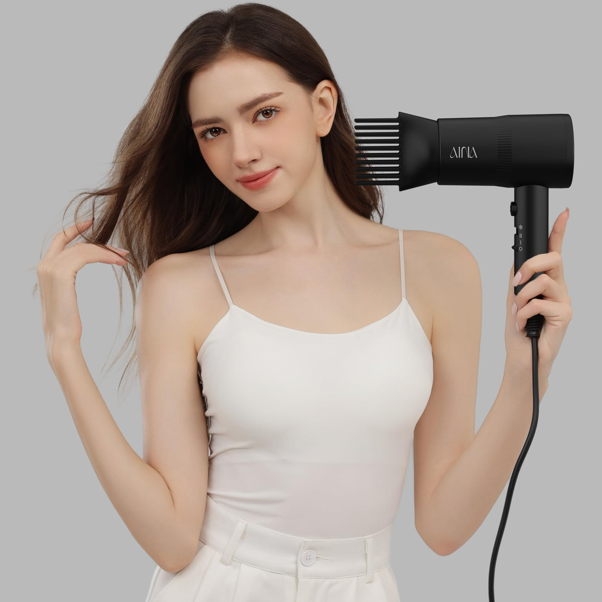 AINA Vader Black in hand showing scale and travel-friendly portability benefit