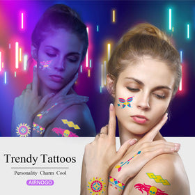 AIRNOGO tattoos glowing on festival attendee under blacklight for vivid visibility