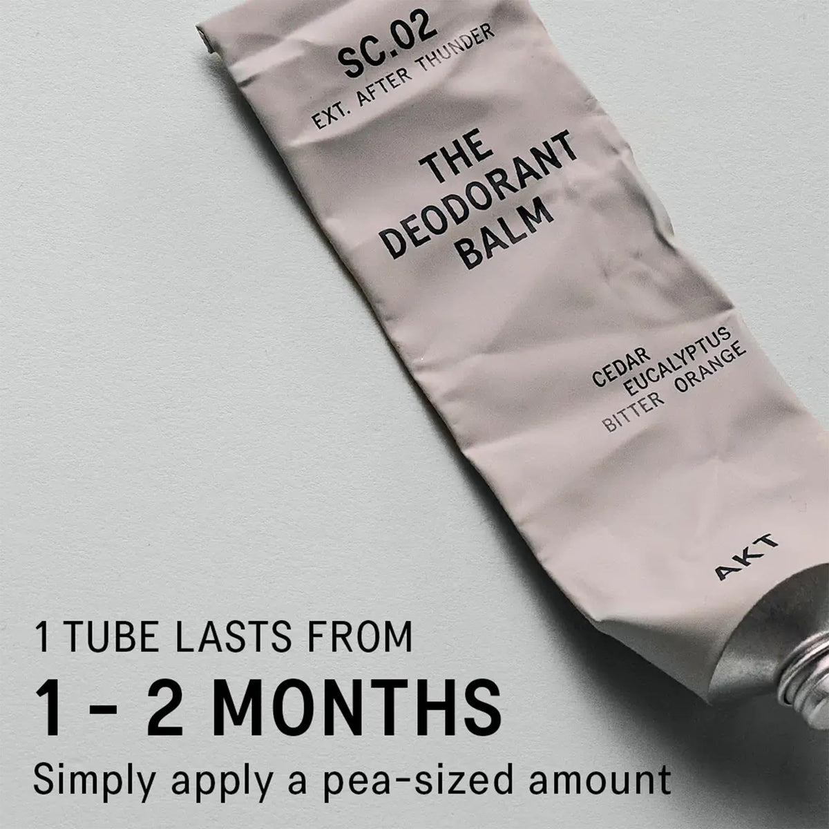 AKT deodorant balm open tube with balm on fingertip demonstrating easy targeted application
