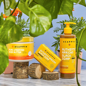 Alaffia smoothing shea butter into hair ends showing reduced breakage and added shine