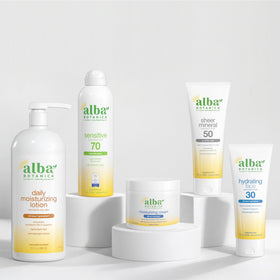 Alba Botanica sunscreen used at beach with child wearing sun hat showing active protection