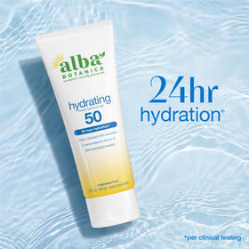 Alba Botanica 3oz bottle next to passport showing travel-friendly size and convenience