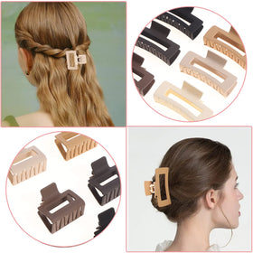 Hand holding Alemaky clips to show scale, demonstrating large and medium sizes for versatile styling