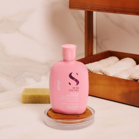 ALFAPARF MILANO shampoo poured into palm showing easy lather and manageable application