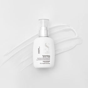 ALFAPARF MILANO bottle in hand for size scale illustrating travel-friendly 4.23 oz convenience