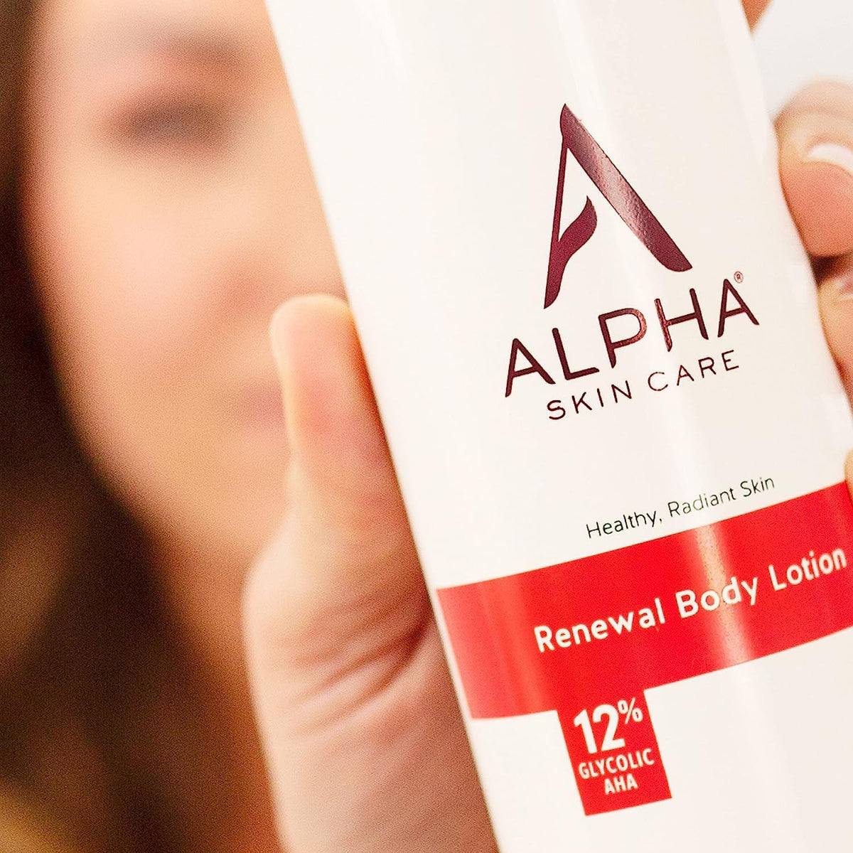 Alpha 12 oz bottle held in hand for scale and travel-friendly size