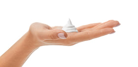 Amazon Basics tube held in hand to show size and convenient travel-friendly benefit