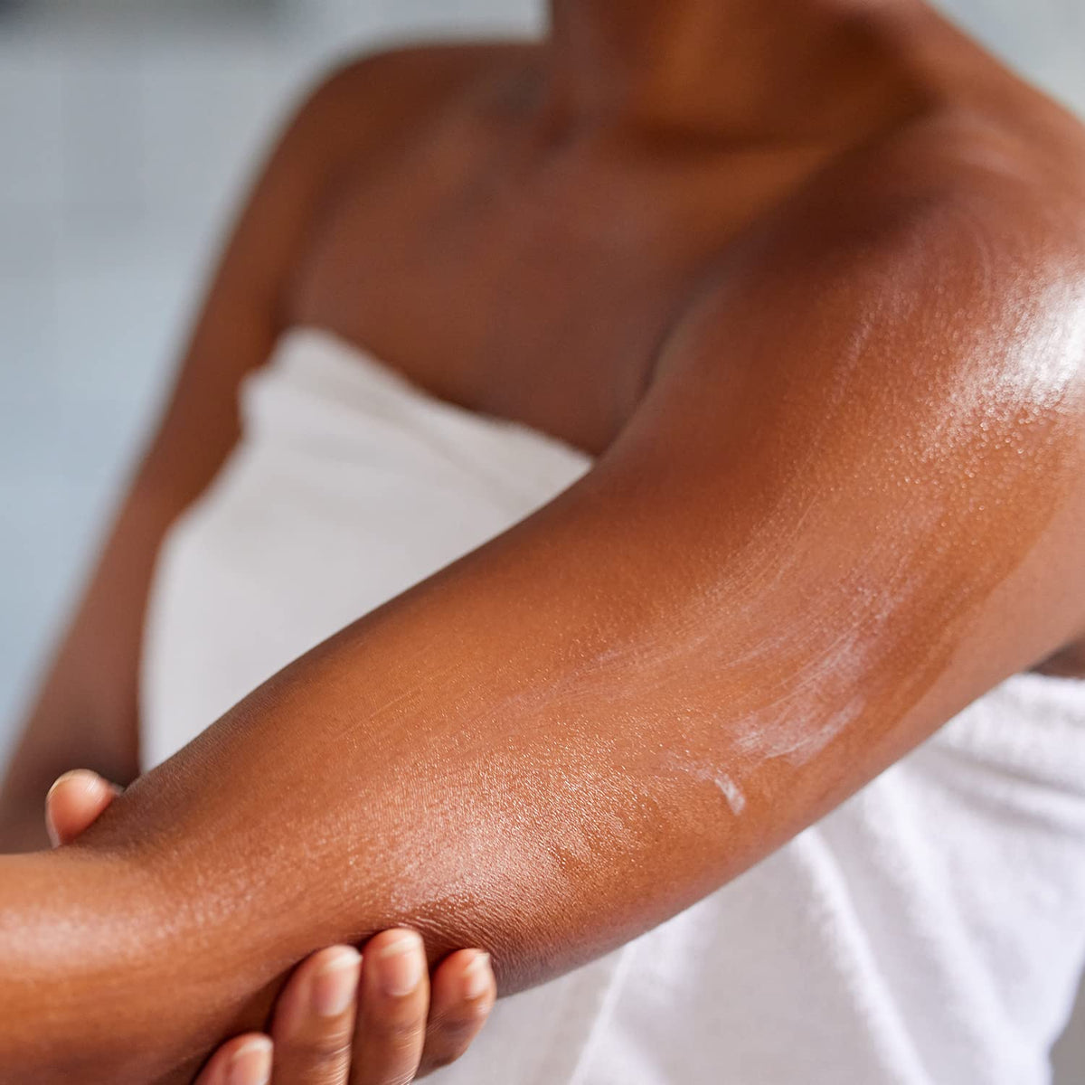 amazon essentials used on model's face and arm showing gentle full-body hydration