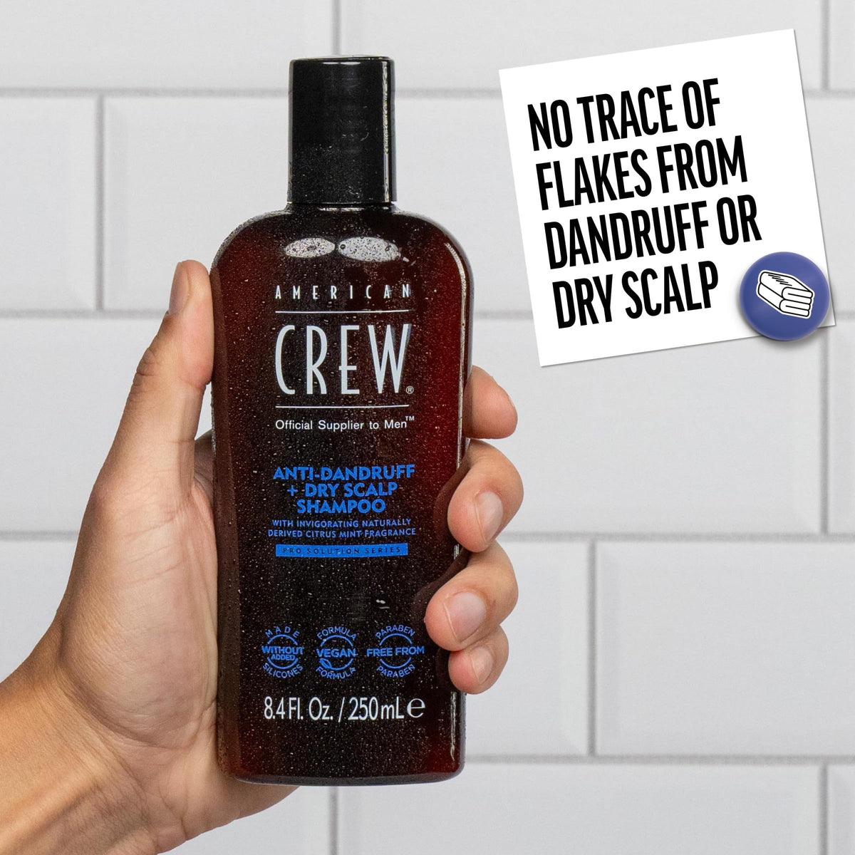 American Crew bottle held in hand showing size and easy handling benefit