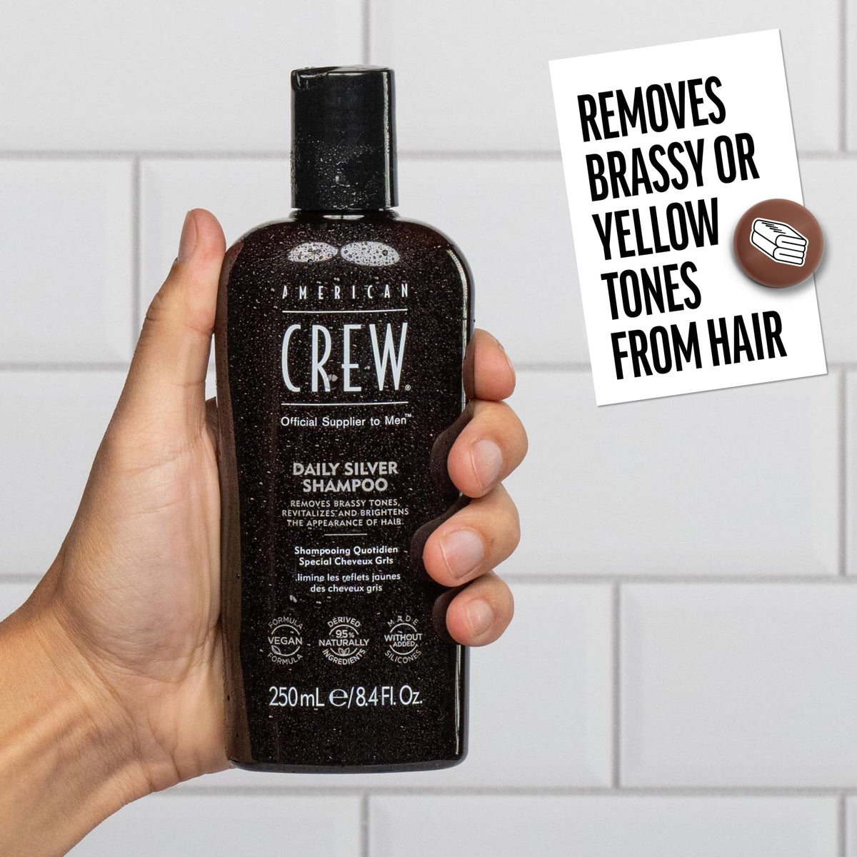 Man using American Crew shampoo in shower demonstrating gentle cleansing and tone correction