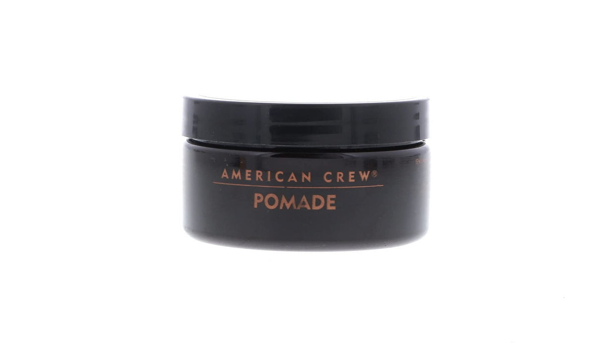 American Crew pomade being applied to slick-back hairstyle for polished finish