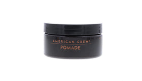 American Crew pomade being applied to slick-back hairstyle for polished finish