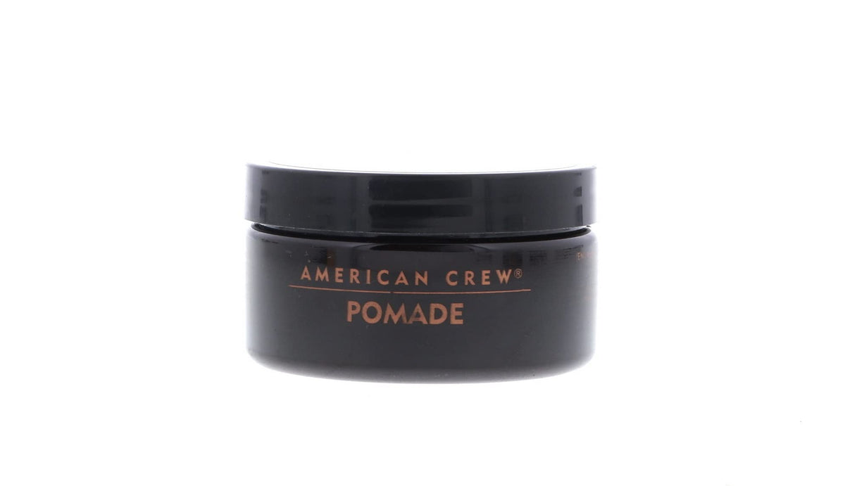 Model with slicked-back hair styled using American Crew pomade for polished shine