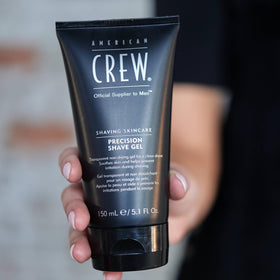 American Crew bottle in hand to show 5.1 fl oz scale and travel-friendly benefit