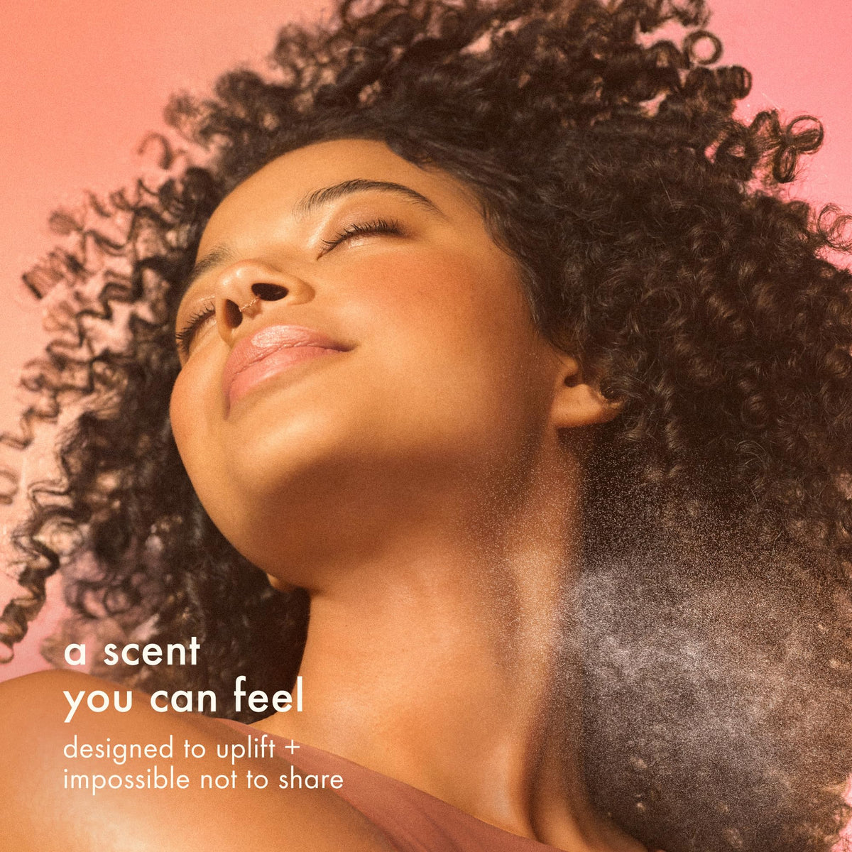 amika aura being spritzed into hair to refresh scent and boost confidence